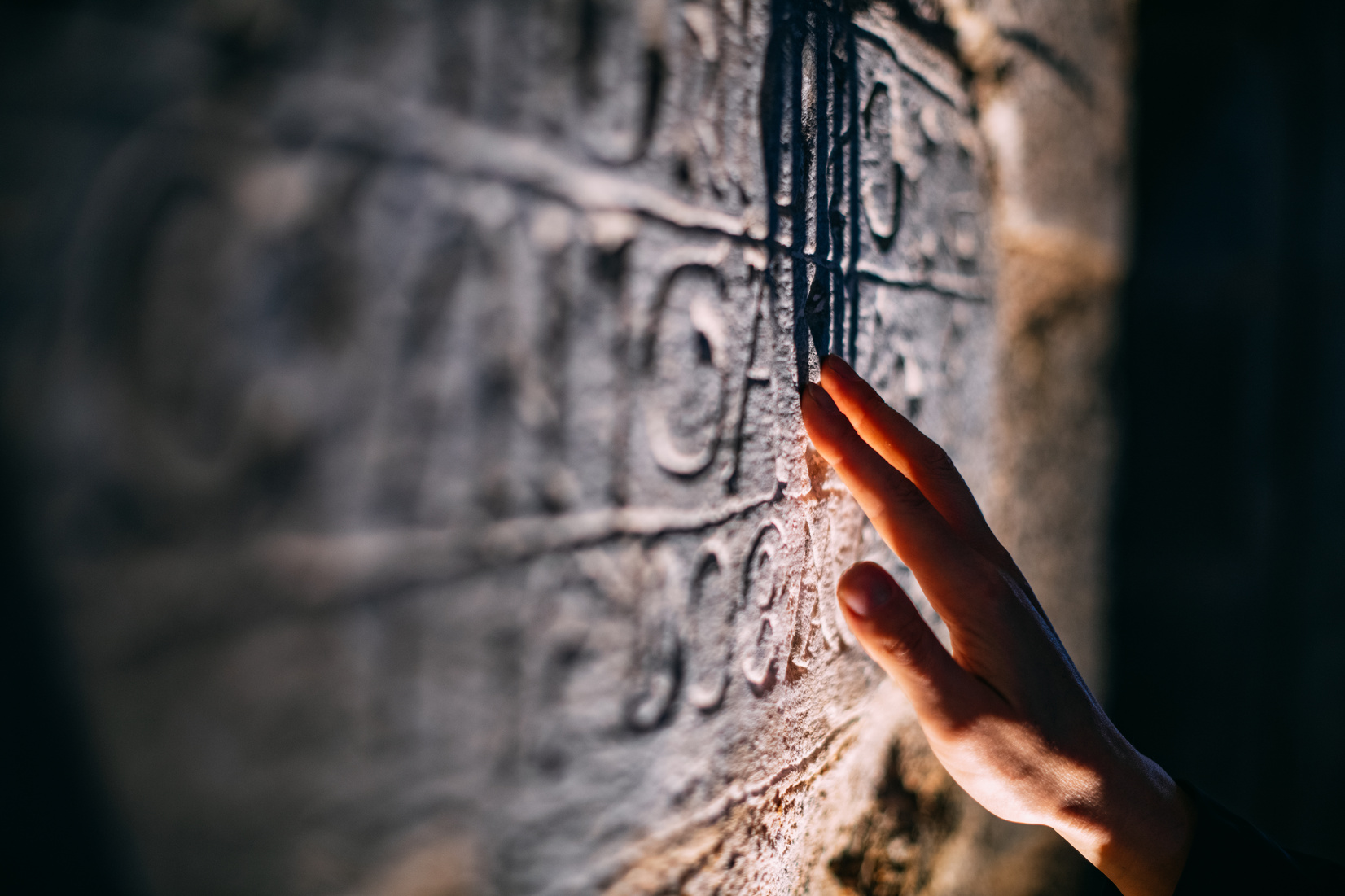 Archaeologist Examines Ancient Inscription